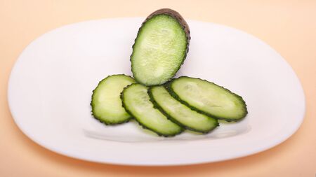 sliced fresh cucumbers on a white plate. chopped gherkins.
の写真素材