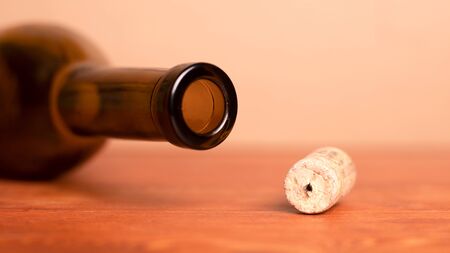 Wine cork and lying empty  bottle  on the table .の写真素材