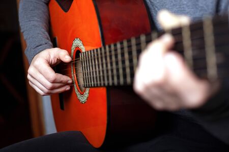 girl playing an acoustic guitar. string musical instrument guitar.
