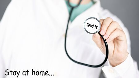 doctor holds a stethoscope, concept viral pandemic covid-19.text Stay at home.の写真素材