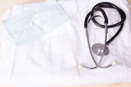 stethoscope and medical mask on a white medical coat.