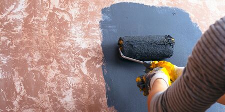 home repair concept.
girl paints a wall paint.の写真素材