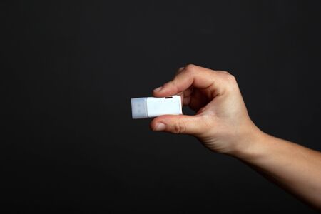 flash drive in hand on a dark black background. secret digital information.の写真素材