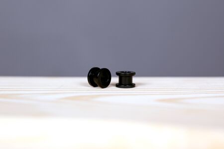black piercing tunnels. ear piercing accessories closeup.の写真素材