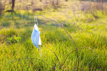 planet pollution with dirty medical masks. spring quarantine of the coronavirus pandemic covid-19.の写真素材