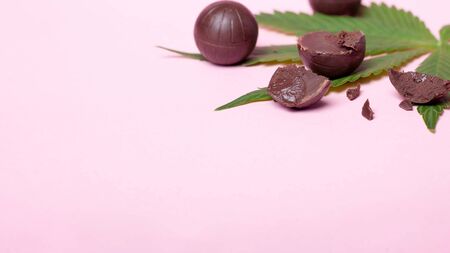 chocolate candy with THC content on pink background. marijuana food, recreational soft drugs copy space.の写真素材