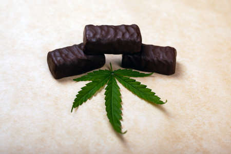 cannabis sweets ,chocolate candies with a leaf of marijuana.の写真素材