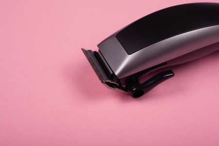 hair clipper close-up on a pink background. hairdresser tool .