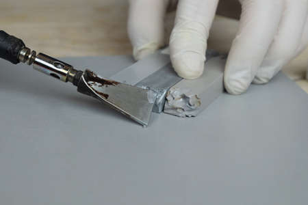 wax pencils and a soldering iron close-up,tools for repairing chips and scratchesの写真素材