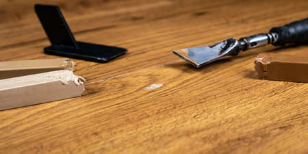 repair of damage to laminate and parquet with waxの写真素材