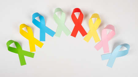 multicolored awareness ribbons symbol closeup on white background