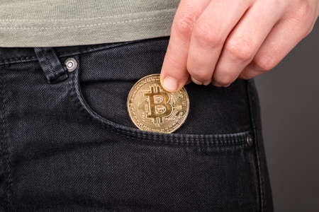 accumulation of bitcoin,gold btc coin in pocketの写真素材