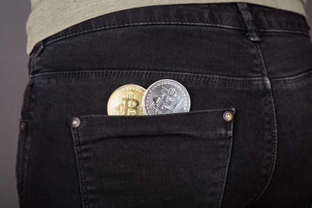 bitcoin coin in pants pocket,accumulation of cryptocurrencyの写真素材