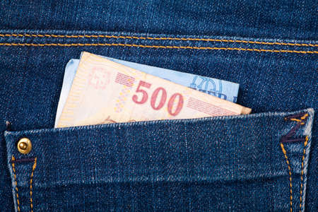 paper money in jeans pocket close-up, savings and wealth concept