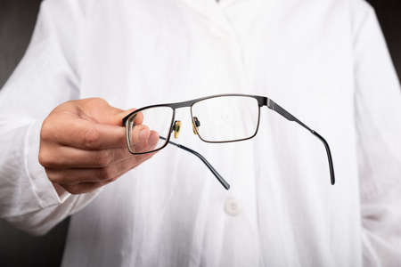 optician doctor gives glasses to a patient to improve vision.の写真素材