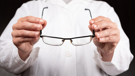 optician doctor gives glasses to a patient to improve vision.