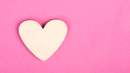 valentine wooden heart on pink background with copy spaceの写真素材
