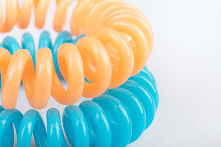 multicolored spiral hair ties close up on white backgroundの写真素材