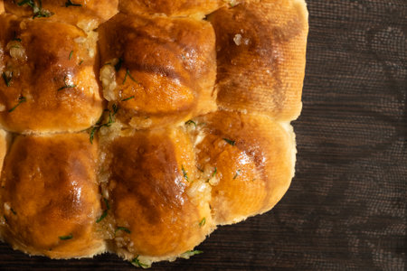 freshly baked hot wheat buns with garlic cool down after the oven
