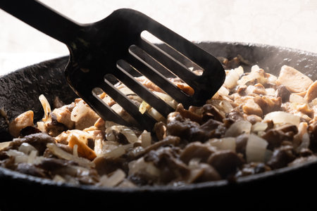 cooking fried mushrooms with onions, stir mushroomsの写真素材