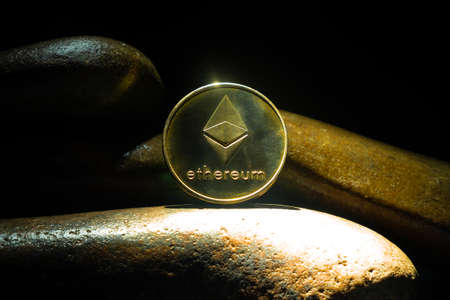 Ethereum cryptocurrency gold coin close up, leading crypto eth money