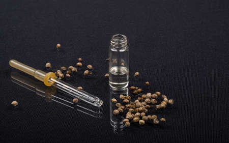 pipette and glass bottle with hemp oil, essential oil and marijuana seedsの写真素材