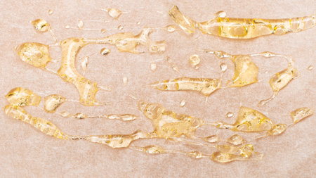 drops of amber cannabis wax, medical marijuana concentrate on a white background close-upの写真素材