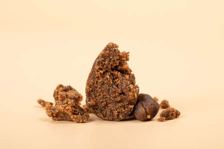 high thc extract, crumbled cannabis hashish slices on beige background