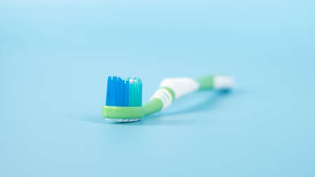 toothpaste and brush on a blue background, oral and dental care concept