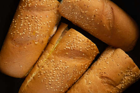 sliced sandwiches, with golden bread and sesame seeds