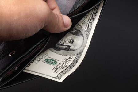 get money from the wallet on a dark background, 100 dollar banknote