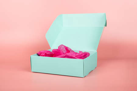 open turquoise gift box with a cosmetic on a pink background,valentine day