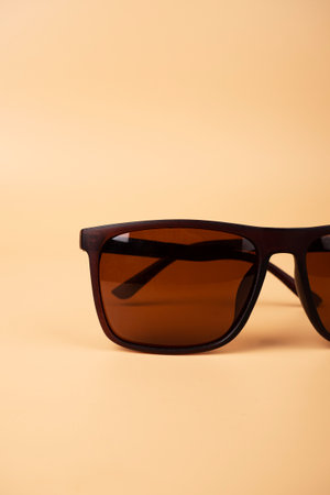 brown solar polarized safety glasses closeup on a beige backgroundの写真素材