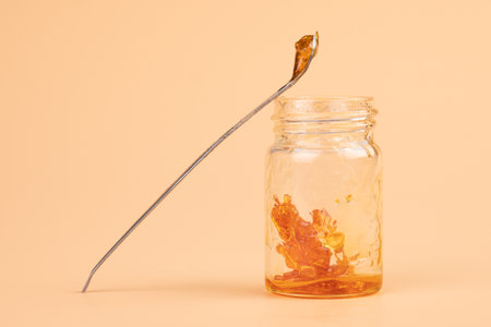 a jar and dab stick of cannabis resin for smoking with a high content of THC.の写真素材