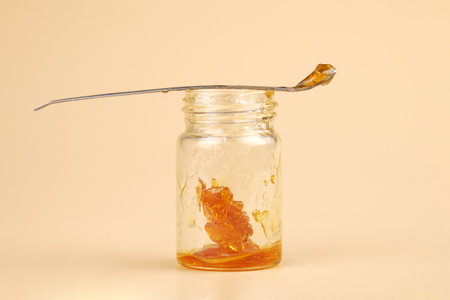 golden cannabis extract, marijuana bottle with resin and dabbing stick.の写真素材