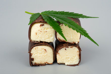 green marijuana leaf and chocolate sweet covered milk cheese with cannabis oil.の写真素材