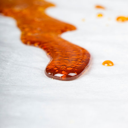 bho extract golden cannabis distillate wax for smoking vape in a glass container.の写真素材