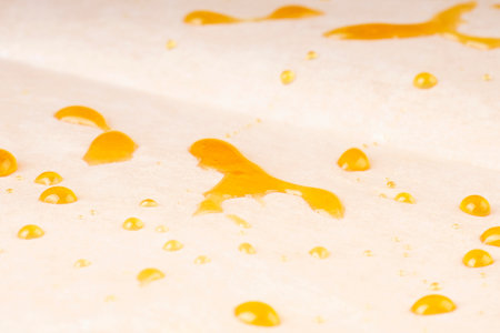 golden drops of cannabis resin high thc on paper, extract dab closeup.の写真素材