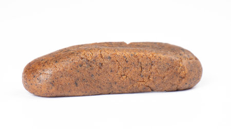 isolated cannabis hash piece, brown hashish on white background.の写真素材