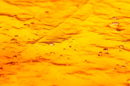 gold cannabis resin ,high thc wax on paper close up.の写真素材