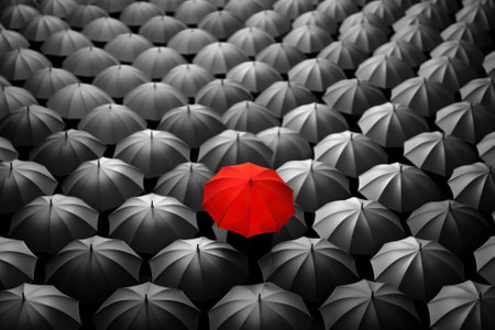 A striking red umbrella stands out in a sea of black umbrellas, symbolizing individuality and uniqueness generative ai.の素材