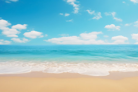 Calm waves gently approach a sandy beach under a sky dotted with soft white clouds.の素材