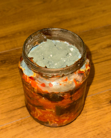 mold in a jar of canned food closeup.