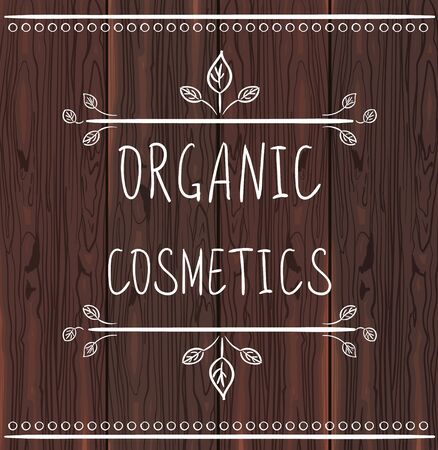 ORGANIC COSMETICS handwritten letters on brown wood backgroundのイラスト素材