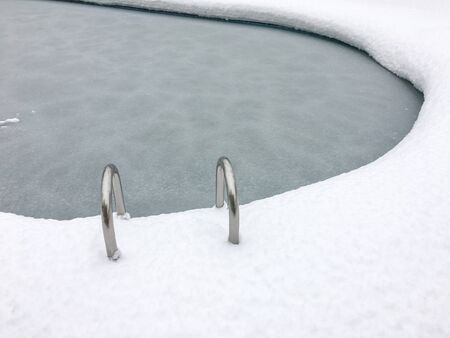 frozen swimming pool in the snowの写真素材