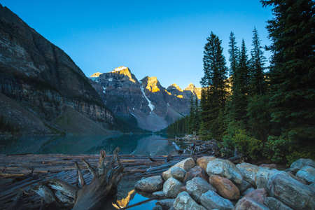 Lake Moraine in Banff National Park. Looking toward driftwood and rocks in the foreground.