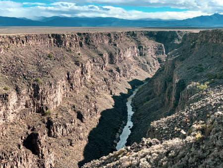Rio Grande Gorge river Taos New Mexico Southwest canyon ravine blue dramatic skyの写真素材