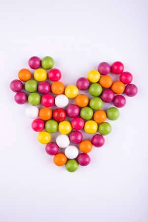 colored gums and candies on a white backgroundの写真素材