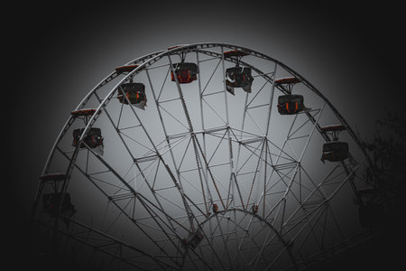 Ferris wheel on dark background. Black and white image of ferris wheel.の写真素材