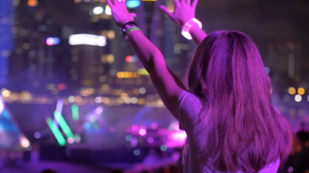 Silhouette of girl enjoy brightly colorful fireworks in the night sky. New year celebration in Sibgapore.の写真素材